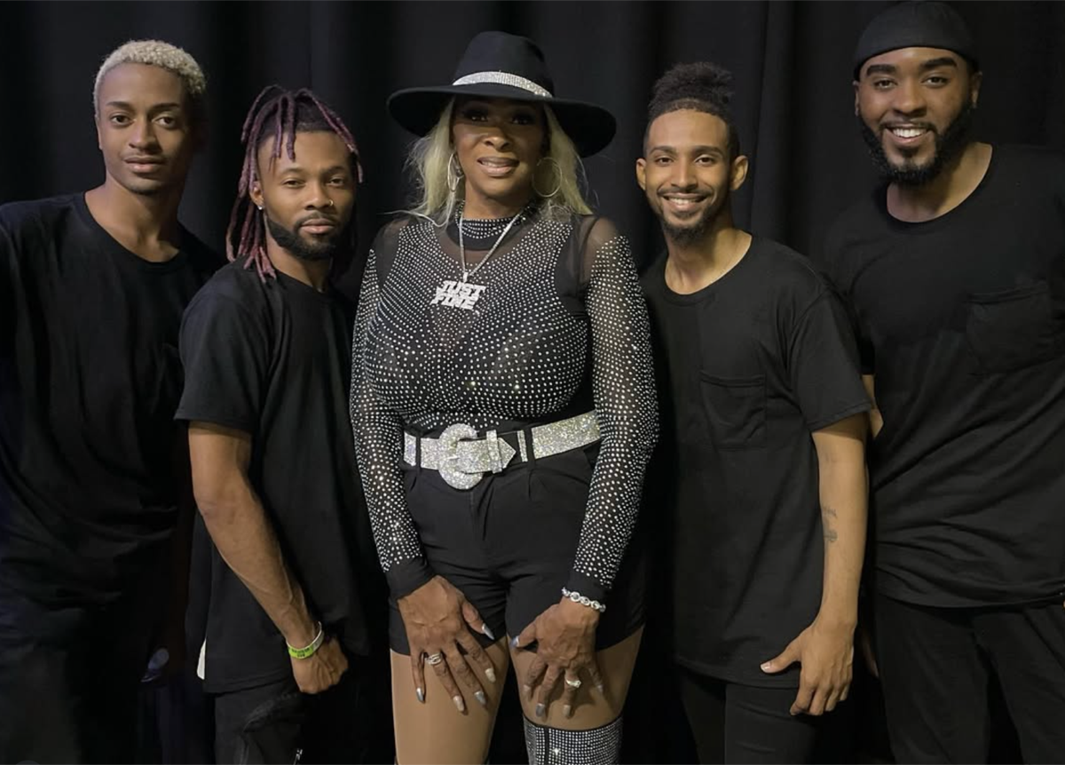 Tre’Jae posing with members of her band