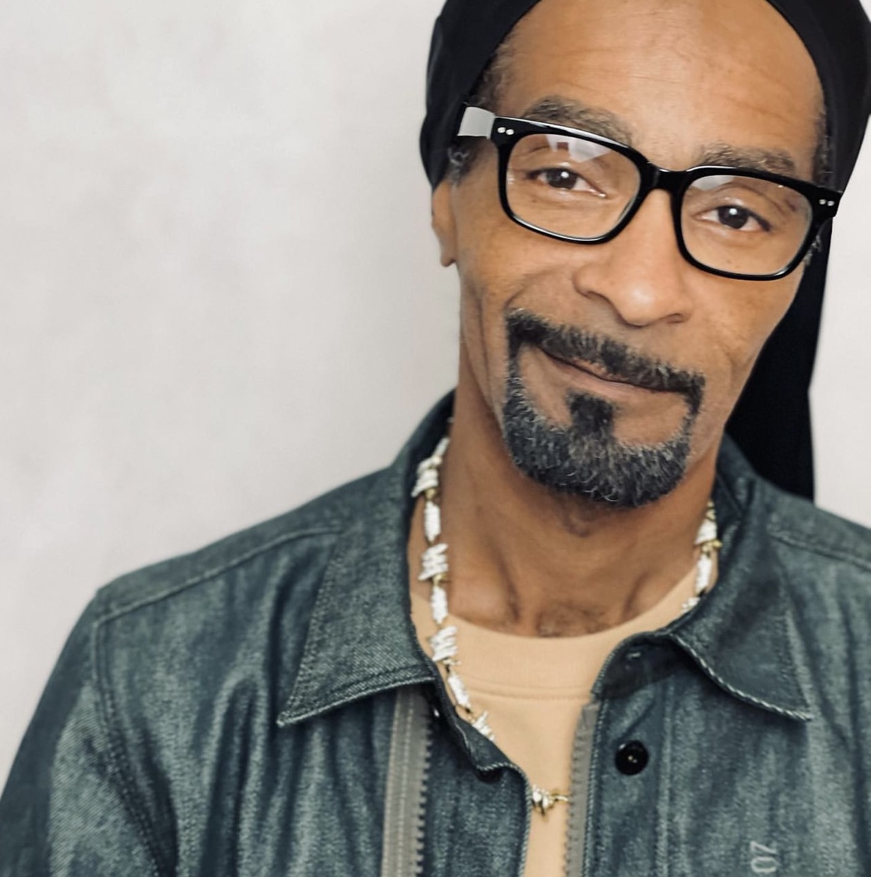 A portrait of Erich Finch as Snoop Dogg wearing glasses